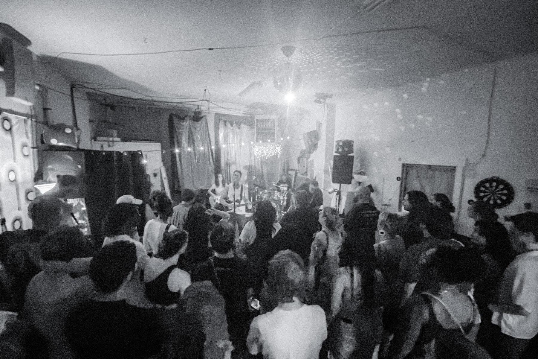 Magnum Dopus playing a packed house show under a disco ball